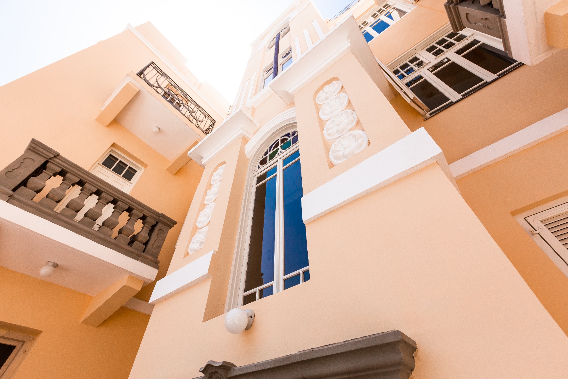 Facade detail — central window and palm motifs